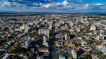 Drone footage of the city of São José dos Pinhais, located in the dynamic metropolitan region of Curitiba, on a day with a blue sky and some clouds, showing the central area.