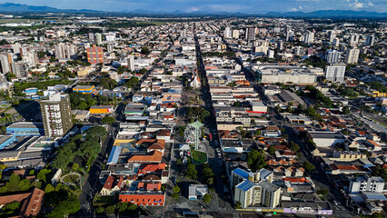 Drone footage of the city of S&atilde;o Jos&eacute; dos Pinhais, located in the dynamic metropolitan region of Curitiba, on a day with a blue sky and some clouds, showing the central area.