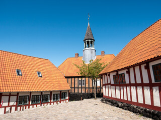Courtyard with half-timbered buildings and historic town hall museum in old town Ebeltoft, Denmark