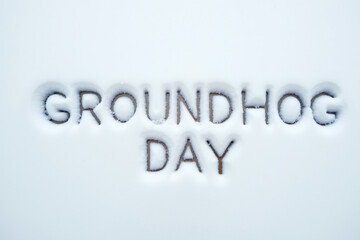 Groundhog Day text written in snow, winter holiday concept with copy space.