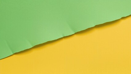 Torn colored paper with green and yellow sections.