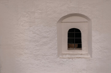 Fototapeta premium An arched window with a lattice in an Orthodox church