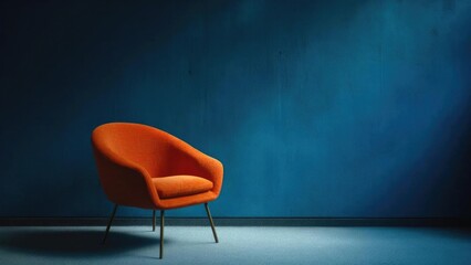 Orange upholstered lounge chair with metal legs in a minimalist blue-walled room. Concept Minimalist interior, Orange upholstered lounge chair, Blue-walled room, Modern furniture, Metal legs