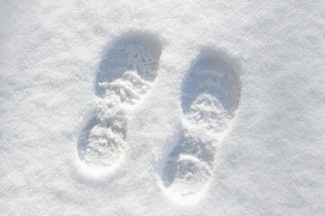 Human foot prints in the fresh white snow