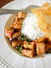 Steamed rice with stir-fried pork sausage, chili, and garlic, and a fried egg.