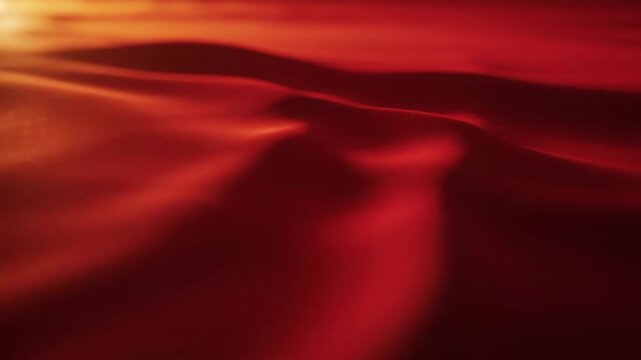 Abstract red fabric texture with soft lighting and fluid movement