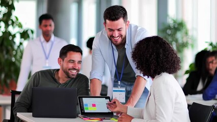 Diverse group of professionals collaborating on a project using a laptop and tablet.