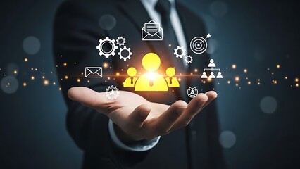 Professional businessman holding a glowing golden human icon surrounded by marketing, email, and strategy symbols for CRM and talent management