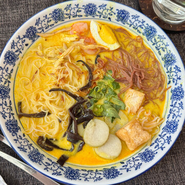 Colorful displayed dish of Indonesian cuisine laksa in restaurant