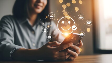 Happy customer experience and online service rating concept with a woman using a smartphone with a glowing smiley face and social icons