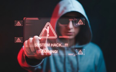 Anonymous hacker in a hoodie pointing at a digital red alert screen displaying system hack warning for cybersecurity threat concept