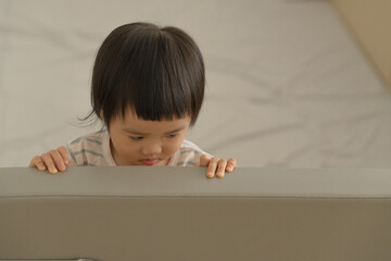 Peaceful Baby Lying on Bed with Soft Natural Light.