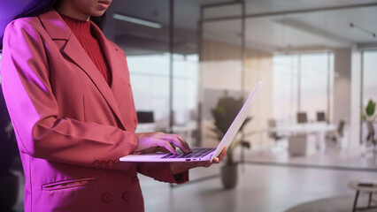 Professional businesswoman uses laptop in modern office, corporate environment technology workflow digital communication concept, leadership productivity innovation contemporary workspace