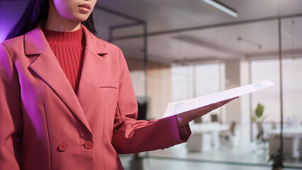 Business professional presenting inventory report in modern office, holding document with charts data analysis concept, management planning corporate workflow financial overview organized records