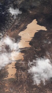 Satellite view of desert lake in Niger, aerial flyover vertical footage based on NASA imagery