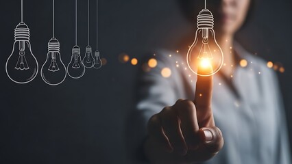Innovative business woman touching a glowing lightbulb idea icon representing inspiration and creativity on a dark background