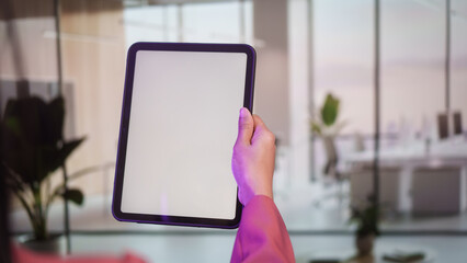 Business professional holding blank white tablet screen in modern office, mockup display for digital content, presentation concept, technology communication corporate branding clean interface