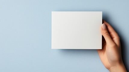 Presentation of plain card held by hand with studio lighting for branding purposes