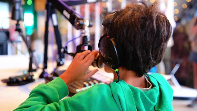 Kids engaging in science and technology workshops, learning about sound recording and broadcasting, using headphones and mixing equipment in an educational museum setting