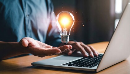Creative light bulb concept idea with glowing illumination above a hand, symbolizing inspiration and innovation in modern working environment
