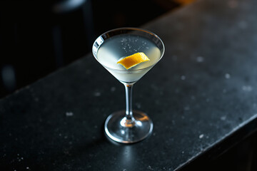 Martini glass with lemon twist on bar counter