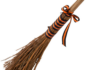 Halloween witch broom with orange and black ribbon decoration on white