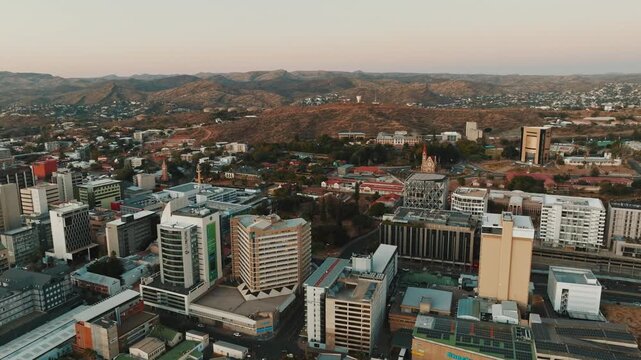 Stunning aerial drone footage of Windhoek, the capital city of Namibia. Modern cityscape with urban streets, buildings, and infrastructure captured from above