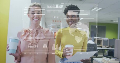 Holding cups, doc, women in pink and mustard reviewing hologram charts and map in open office