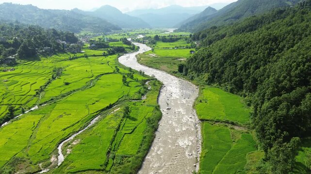Aerial Drone View of Nuwakot Valley with River Dividing Paddy Fields and Surrounding Mountains