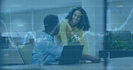 Leaning yellow-top woman engaging seated blue-shirt man in office laptop papers charts-overlay