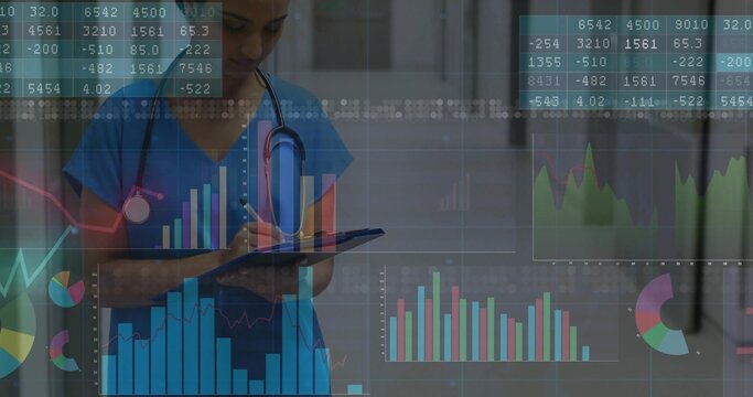 Entering data nurse in blue scrubs tapping tablet in clinic corridor with stethoscope and charts - Powered by Adobe