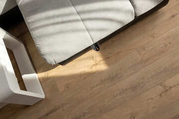 Natural wood laminate parquet floor. Room with floating laminate in new apartmen.  Cozy home interior, modern design
