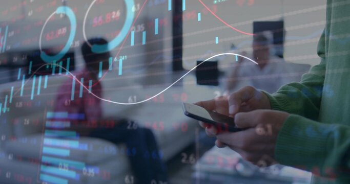 Holding smartphone, man in green sweater viewing financial charts at office lounge, copy space - Powered by Adobe