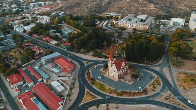 Stunning aerial drone footage of Windhoek, the capital city of Namibia. Modern cityscape with urban streets, buildings, and infrastructure captured from above