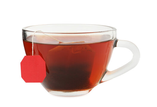 Tea brewing. Cup with tea bag isolated on white
