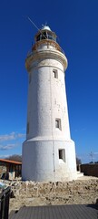 The some lonely white lighthouse on the blue sky