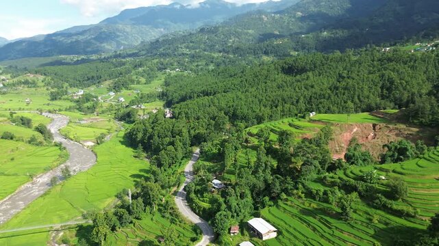 Aerial Drone View of Nuwakot Valley with a Beautiful Road Along Hills and Paddy Fields