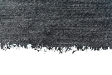 Piece of torn denim on a white background. Denim texture