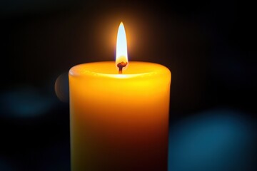 Illuminating Hope: Close-Up of Burning Candle Flame Symbolizing Tranquility in Dark Background