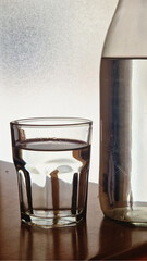 Glass of water and bottle showing hydration