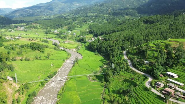Aerial Drone View of Nuwakot Valley with River Dividing Paddy Fields and Surrounding Mountains