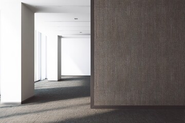 Modern office interior with textured walls and natural light, highlighting minimalist design and spacious floor plan for productivity.