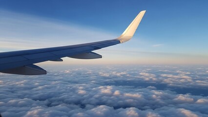 Obraz premium Airplane Wing View Above Fluffy Clouds During a Serene Aerial Journey