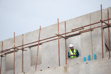inspection, Asian Man working, Architect or contractor working on house building under construction. Professional Architects Engineer construction site. Civil Engineering in safety harthat helmet