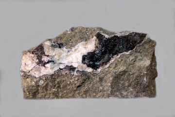 Anthraxilite with black spots on a dark background. Gems, mineralogy, jewelry.
