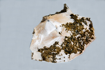 Pectolite with beautiful crystals on a light background. Gems, mineralogy, jewelry.