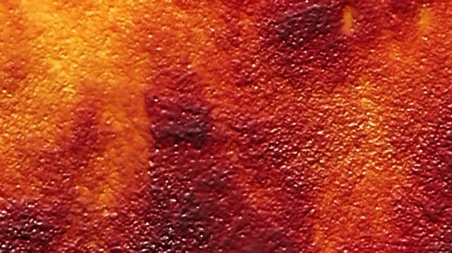 Gelatinous Red and Orange Goo Crawl 4K Loop features textured burnt orange, and dark red matter slowly oozing its way across the screen in a loop.