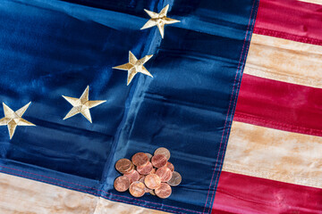 pile of copper pennies on tea stain colonial American flag