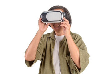Happy senior Asian woman wearing VR headset glasses watching metaverse game on white background. Elderly technology lifestyle, virtual reality experience, and digital cyberspace concept.