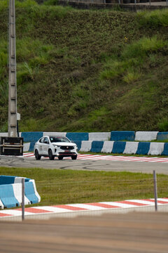 White Fiat Fastback Abarth front view cornering, Sport SUV on race track